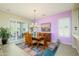 Stylish dining room with modern chandelier and sliding doors leading to backyard patio at 16935 W Desert Blossom Way, Surprise, AZ 85387