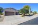 Charming single-story home boasts a three-car garage and attractive desert landscaping in the front yard at 16935 W Desert Blossom Way, Surprise, AZ 85387