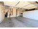 Spacious garage with epoxy floors, storage cabinets, and room for multiple vehicles at 16935 W Desert Blossom Way, Surprise, AZ 85387