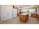Spacious kitchen featuring an island, tile floors, white cabinets, and modern appliances at 16935 W Desert Blossom Way, Surprise, AZ 85387