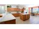 Bright kitchen with wooden cabinetry, modern appliances, and a breakfast nook at 16935 W Desert Blossom Way, Surprise, AZ 85387