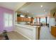 Bright, open kitchen with a breakfast bar, lots of counter space, and a view to the dining area at 16935 W Desert Blossom Way, Surprise, AZ 85387