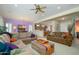 Spacious living room with neutral decor, comfortable seating, and a ceiling fan at 16935 W Desert Blossom Way, Surprise, AZ 85387