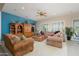 Comfortable living room featuring plush sofas, a ceiling fan, and lots of natural light at 16935 W Desert Blossom Way, Surprise, AZ 85387