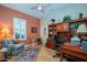 Cozy home office with custom built-ins, a comfortable chair, and natural light at 16935 W Desert Blossom Way, Surprise, AZ 85387