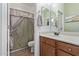 Well-lit bathroom featuring a single vanity and shower at 17193 N Rosemont St, Maricopa, AZ 85138