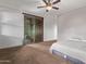 Spacious primary bedroom with ceiling fan and sliding glass door at 17193 N Rosemont St, Maricopa, AZ 85138