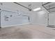 Spacious garage with overhead storage racks, water heater, epoxy floor, and SolarCity power system at 17193 N Rosemont St, Maricopa, AZ 85138