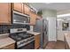 Updated kitchen features stainless steel appliances and tiled flooring at 17193 N Rosemont St, Maricopa, AZ 85138