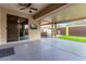 Relaxing covered patio with a ceiling fan, tv, outdoor seating, and jacuzzi at 17193 N Rosemont St, Maricopa, AZ 85138