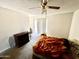 A bright bedroom featuring a ceiling fan and slider access at 17224 N 56Th Dr, Glendale, AZ 85308