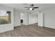 Plank floors accentuate this bedroom with a ceiling fan and bright window at 18234 N Alicia Ct, Maricopa, AZ 85138