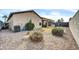 Backyard featuring gravel landscaping, sparse grass, and a built-in grill at 18298 N Kari Ln, Maricopa, AZ 85139