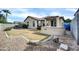 Backyard with gravel landscaping, patio, sparse grass, and a built-in grill at 18298 N Kari Ln, Maricopa, AZ 85139