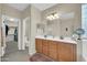 Primary bathroom with double vanities, a large mirror, and a walk-in closet access at 18298 N Kari Ln, Maricopa, AZ 85139
