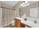 Well-lit bathroom with vanity area, shower/tub combo, and tile floors at 18298 N Kari Ln, Maricopa, AZ 85139