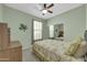 Bedroom with ceiling fan, mirror closet and a comfortable bed at 18298 N Kari Ln, Maricopa, AZ 85139