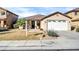 Charming single-story home with a two-car garage, desert landscaping, and a tiled roof at 18298 N Kari Ln, Maricopa, AZ 85139