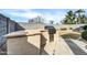 Outdoor built-in grill in the backyard, featuring concrete flooring and a small grassy area at 18298 N Kari Ln, Maricopa, AZ 85139