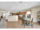 Eat-in kitchen with tile flooring, wood cabinets, stainless appliances, and a breakfast bar at 18298 N Kari Ln, Maricopa, AZ 85139