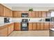 Bright kitchen showcasing wood cabinets, black appliances, tile floors and a breakfast bar at 18298 N Kari Ln, Maricopa, AZ 85139