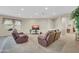 Bright living room featuring carpeted flooring, neutral paint, and comfortable seating at 18298 N Kari Ln, Maricopa, AZ 85139