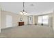 Spacious living room with neutral carpeting, chandelier lighting, and ample natural light at 18298 N Kari Ln, Maricopa, AZ 85139