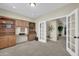 Office space with custom built-in wooden shelving, desk, and French doors at 18298 N Kari Ln, Maricopa, AZ 85139