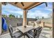 Covered patio featuring a ceiling fan, patio furniture, and a built-in grill at 18298 N Kari Ln, Maricopa, AZ 85139
