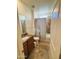 Well-lit bathroom featuring a granite vanity top, tile floors, and a shower-tub combo at 20407 W Calle Encorvada --, Buckeye, AZ 85396