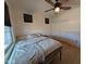Bedroom showing the fan, two windows, and a closet with bi-fold doors with white trim at 20407 W Calle Encorvada --, Buckeye, AZ 85396