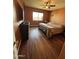 Cozy bedroom featuring hardwood flooring, a window for natural light, and a ceiling fan at 20407 W Calle Encorvada --, Buckeye, AZ 85396