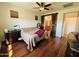 Comfortable primary bedroom featuring hardwood floors, ceiling fan and access to the ensuite bathroom at 20407 W Calle Encorvada --, Buckeye, AZ 85396