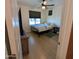 A modest bedroom with light wood floors, simple decor, and a standard ceiling fan at 20407 W Calle Encorvada --, Buckeye, AZ 85396