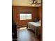 Cozy bedroom with wood floors, side tables, and large window for natural light at 20407 W Calle Encorvada --, Buckeye, AZ 85396