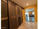 View of hallway with decorative sliding barn doors and view of living area at 20407 W Calle Encorvada --, Buckeye, AZ 85396