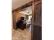 Home office featuring wood floors, modern lighting, and sliding barn doors at 20407 W Calle Encorvada --, Buckeye, AZ 85396