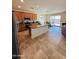 Open-concept kitchen with stainless steel appliances, wooden cabinets and a large island with seating at 20407 W Calle Encorvada --, Buckeye, AZ 85396
