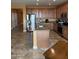 Open kitchen featuring wooden cabinets, granite countertops, stainless steel appliances, and an island at 20407 W Calle Encorvada --, Buckeye, AZ 85396