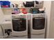 Well-equipped laundry room with front loading washer and dryer, utility sink, and ample storage shelves at 20407 W Calle Encorvada --, Buckeye, AZ 85396