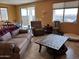 Cozy living room with a comfortable sofa, recliner, and natural light from large windows at 20407 W Calle Encorvada --, Buckeye, AZ 85396