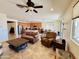 Inviting living room with an open concept design, tile flooring, and view of the kitchen area at 20407 W Calle Encorvada --, Buckeye, AZ 85396