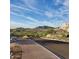 Paved street with desert landscape and golf course view against a mountain backdrop and sunny sky at 20407 W Calle Encorvada --, Buckeye, AZ 85396