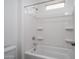 All white bathroom featuring a shower and tub combination with built in shelves at 21291 W Edgemont Ave, Buckeye, AZ 85396