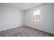 Bedroom with neutral carpet, white walls, and bright natural light at 21291 W Edgemont Ave, Buckeye, AZ 85396