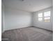 Spacious bedroom with two windows, neutral carpet, and light walls at 21291 W Edgemont Ave, Buckeye, AZ 85396
