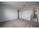 Bedroom with neutral carpet and white walls, adjacent to hallway with open doorways at 21291 W Edgemont Ave, Buckeye, AZ 85396