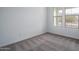 Neutral bedroom featuring carpet, two windows, and white walls at 21291 W Edgemont Ave, Buckeye, AZ 85396