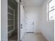 Well-lit entryway with a pantry, stylish sliding door, and tile flooring at 21291 W Edgemont Ave, Buckeye, AZ 85396