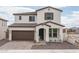 Charming two-story home with a brown tile roof, two-car garage, and professionally designed front yard at 21291 W Edgemont Ave, Buckeye, AZ 85396